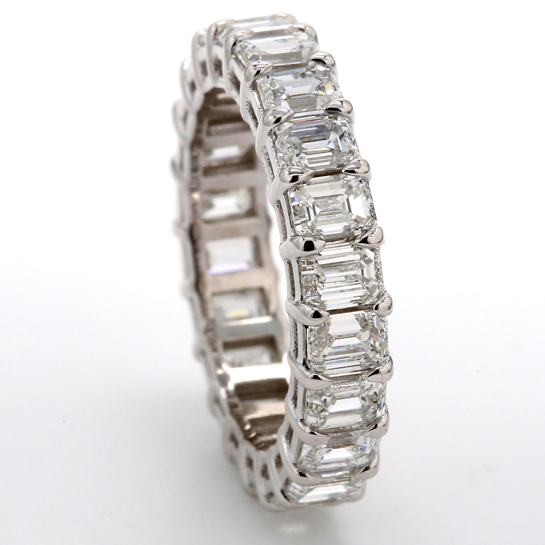 Eternity band in platinum with basket prong set (22) emerald cut diamonds.  D4.08ct.t.w.  Size 5