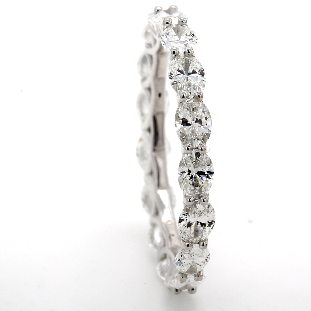 Eternity band east to west style in platinum with prong set (17) oval cut diamonds.  D2.43ct.t.w.  Size 7