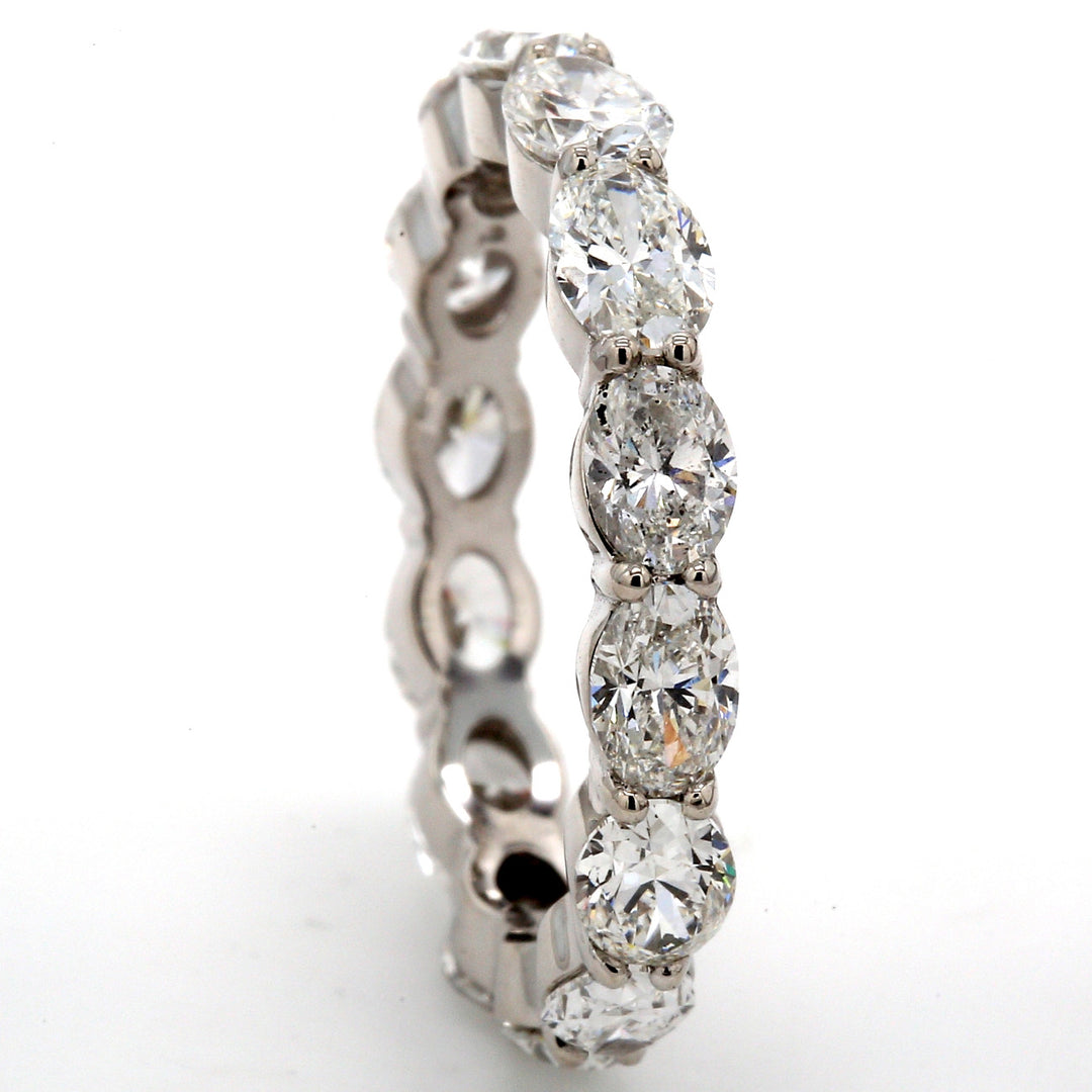 Eternity band east to west style in platinum with prong set (14) oval cut diamonds.  D3.42ct.t.w.  Size 7