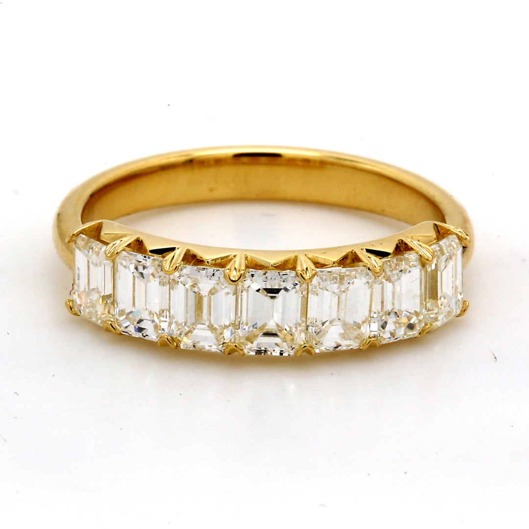 7-stone band in 18K YG with prong set emerald cut diamonds.  D1.72ct.t.w.  Size 6.75