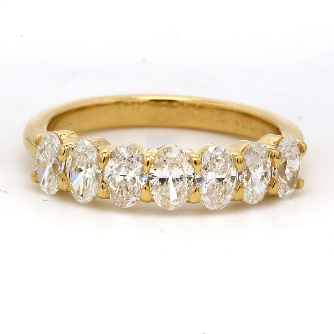7-stone band in 18K YG with basket prong set oval cut diamonds.  D1.30ct.t.w.  Size 7