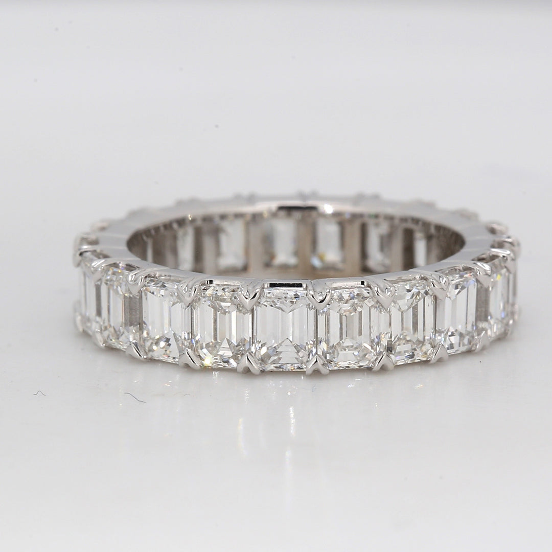 Eternity band in platinum with shared prong set (22) emerald cut diamonds.  D4.31ct.t.w.  Size 5.25