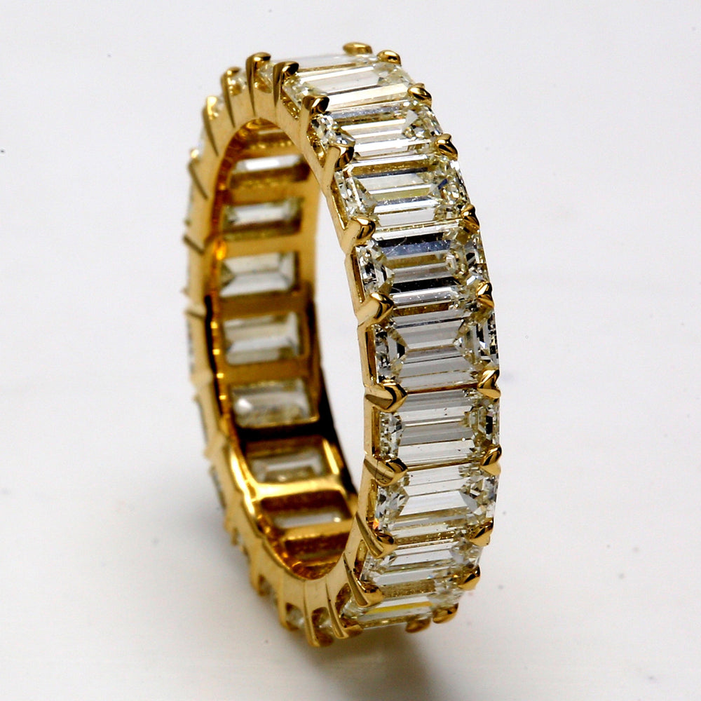 Eternity band in 18K YG with prong set (22) emerald cut diamonds.  D3.72ct.t.w.  Size 4