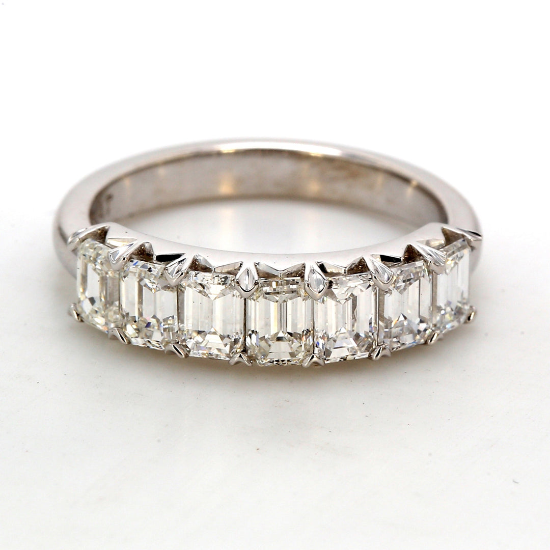 7-stone band in platinum with shared prong set emerald cut diamonds.  D1.58ct.t.w.