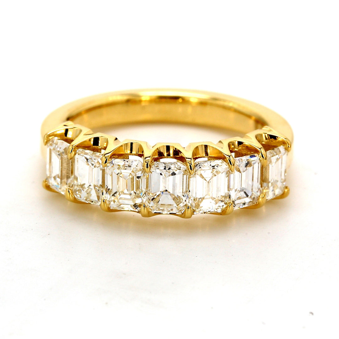 7-stone band in 18K YG with shared prong set emerald cut diamonds.  D1.59ct.t.w.  Size 4.75