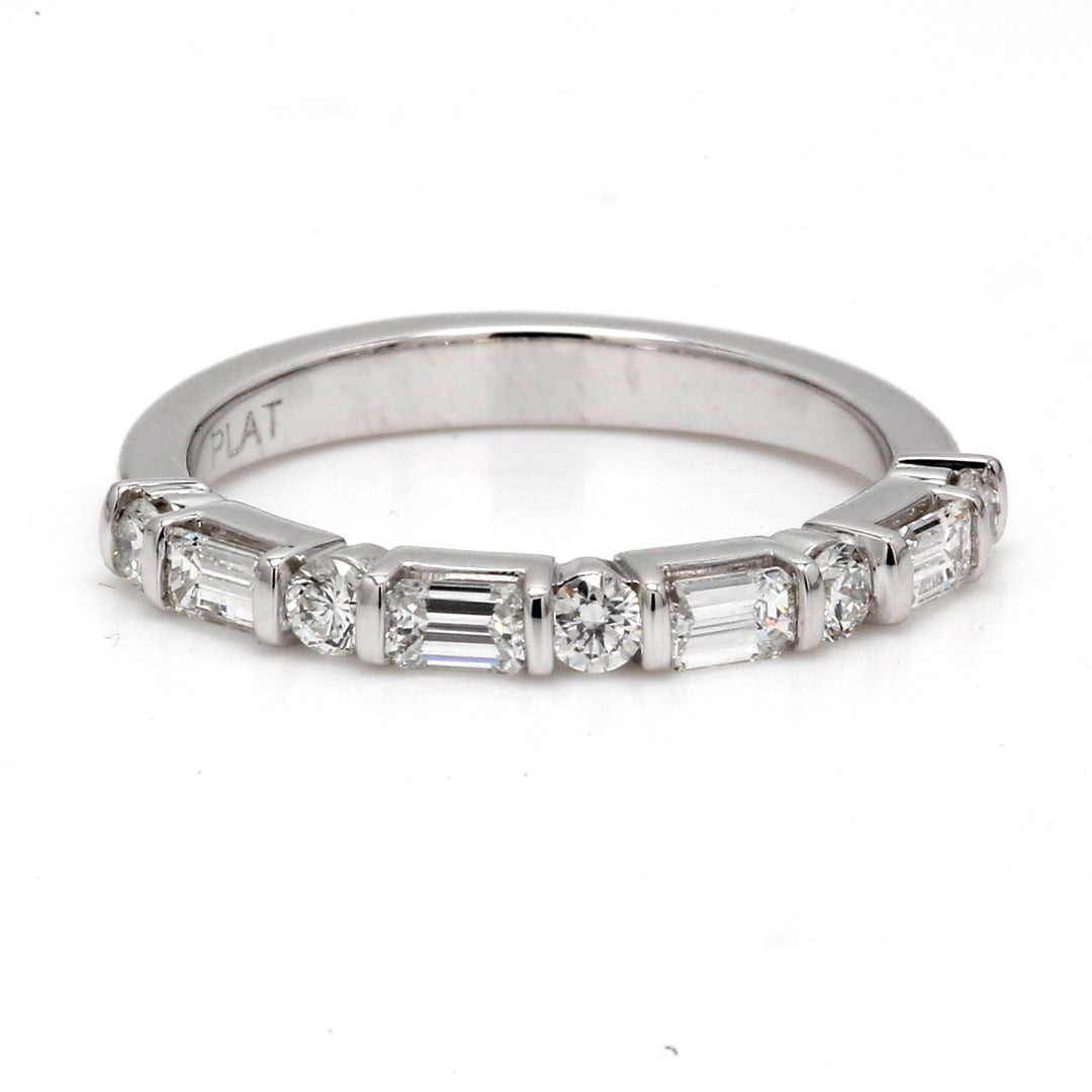 Half way band in platinum with channel set (5) rounds and basket set (4) emerald cut diamonds.  D0.58ct.t.w.  Size 7
