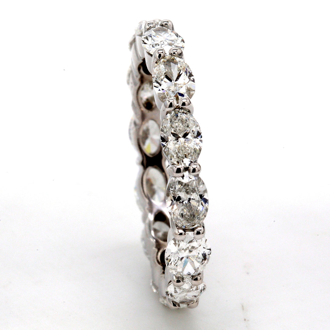 Eternity band east to west style in platinum with prong set (14) oval diamonds.  D2.58ct.t.w.  Size 5.5