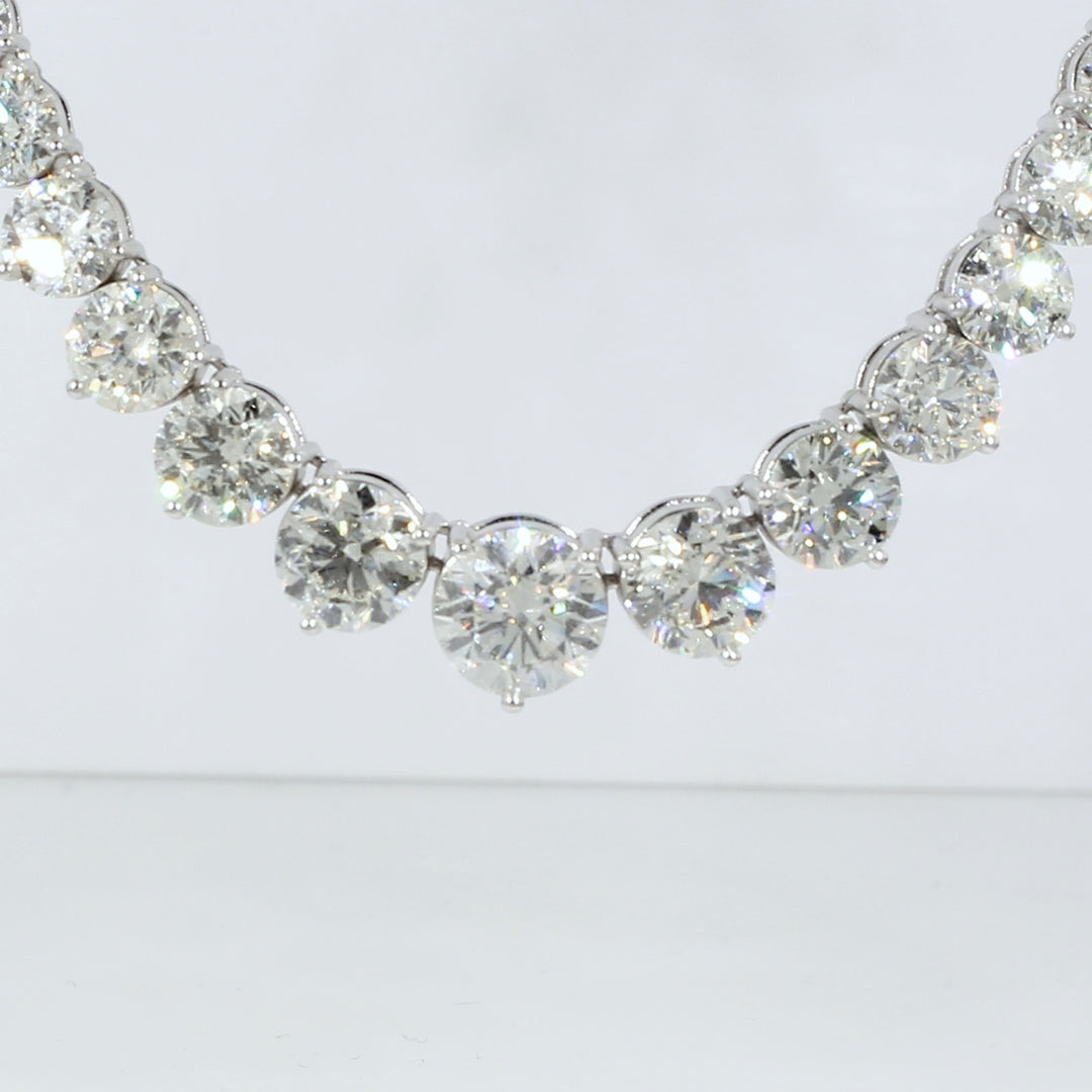 Graduated tennis necklace in platinum with 3-prong set round diamonds.  D26.86ct.t.w.  (Center 2.08ct.)