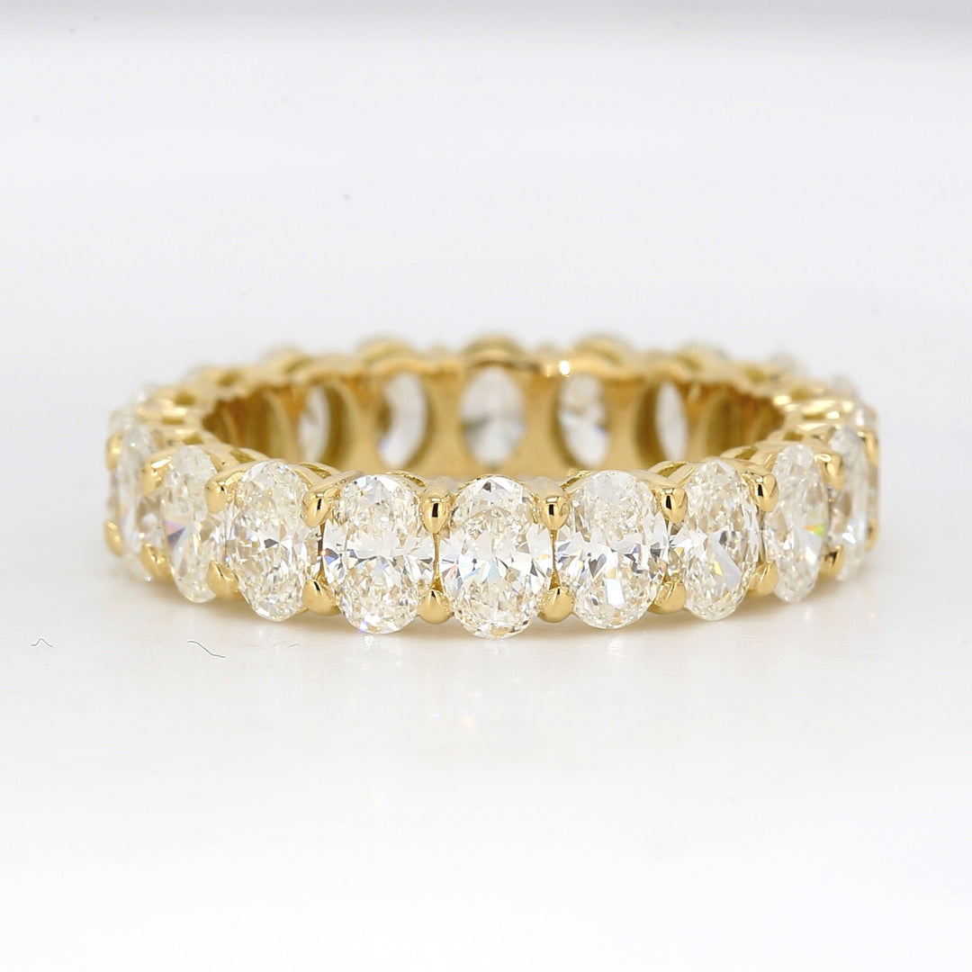 Eternity band in 18K YG with shared prong basket set oval diamonds.  D3.36ct.t.w.  Size 5.5