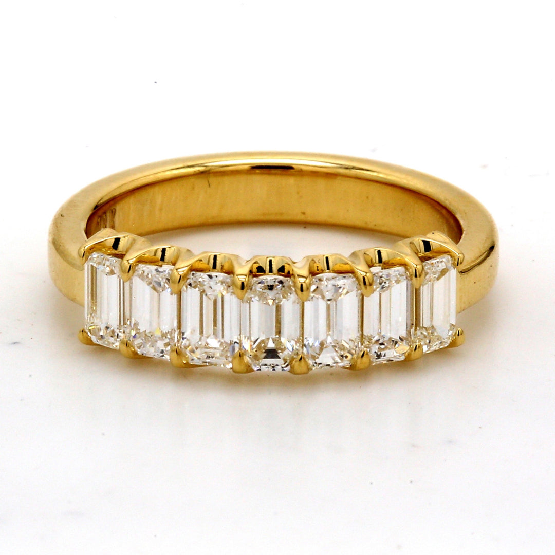 7-stone band in 18K YG with U-prong set emerald cut diamonds.  D1.32ct.t.w.  Size 6