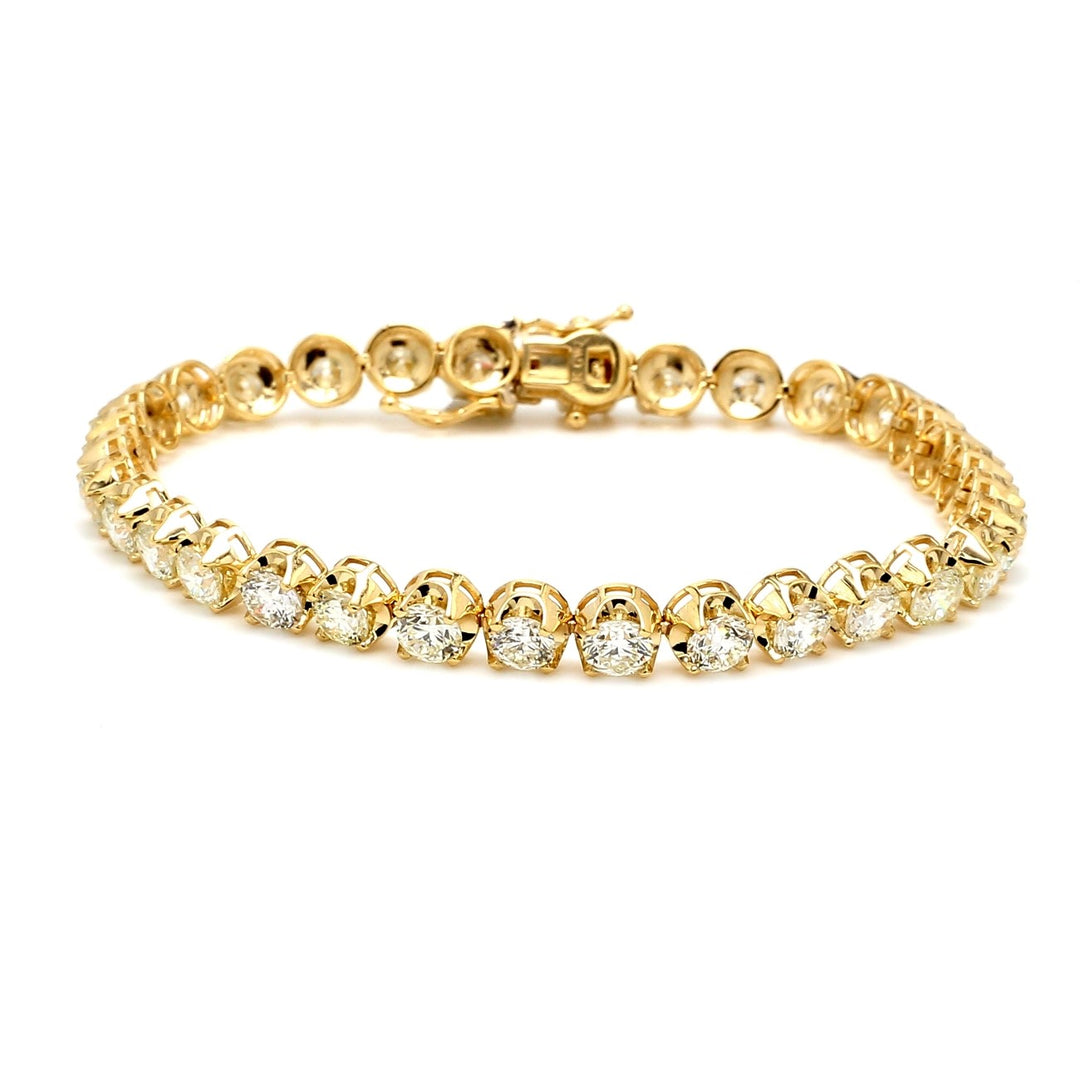 7"" Tennis bracelet in 18K YG with crown style 4-prong set (27) round diamonds.  D13.59ct.t.w.