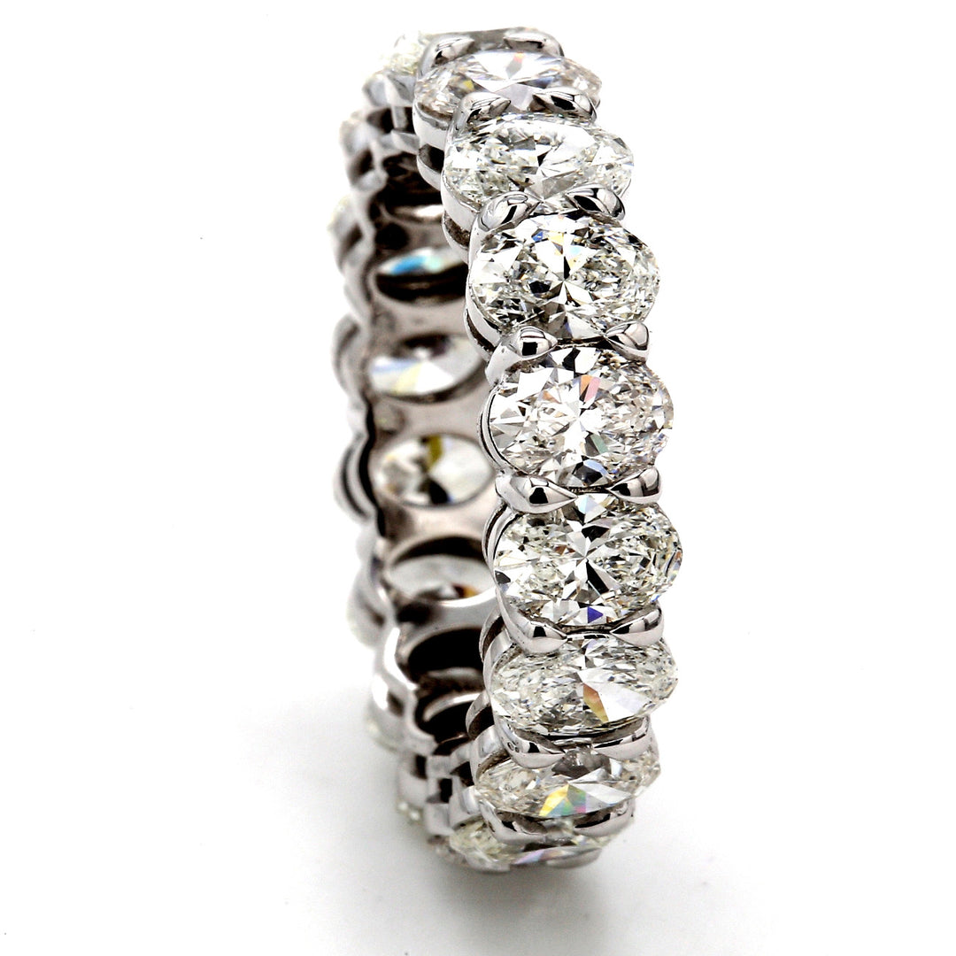 Eternity band in platinum with shared basket prong set (18) oval diamonds.  D5.64ct.t.w.  Size 7