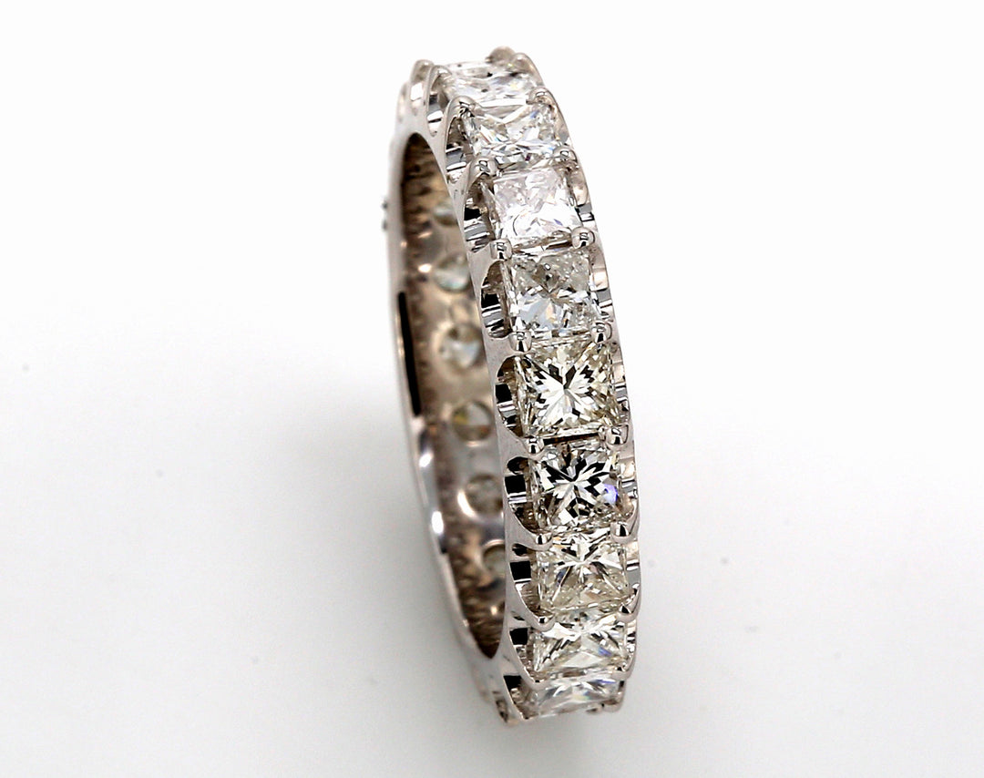 Eternity band in 18K WG with U-prong set (21) princess cut diamonds.  D2.76ct.t.w.  Size 5