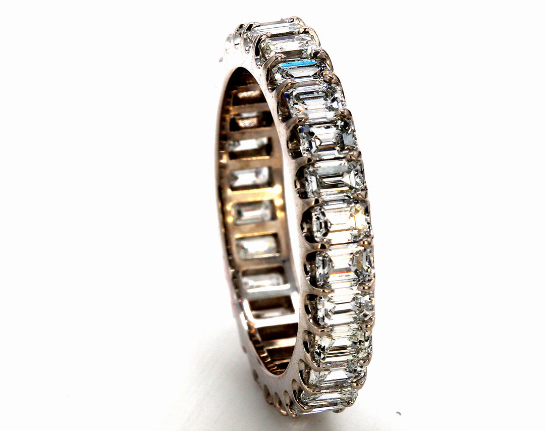 Eternity band in platinum with U-prong set (28) emerald cut diamonds.  D3.05ct.t.w.  Size 6.5