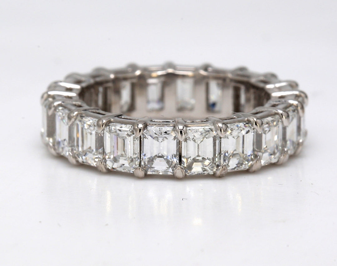 Eternity band in platinum with shared basket prong set (20) emerald cut diamonds.  D4.93ct.t.w.  Size 5