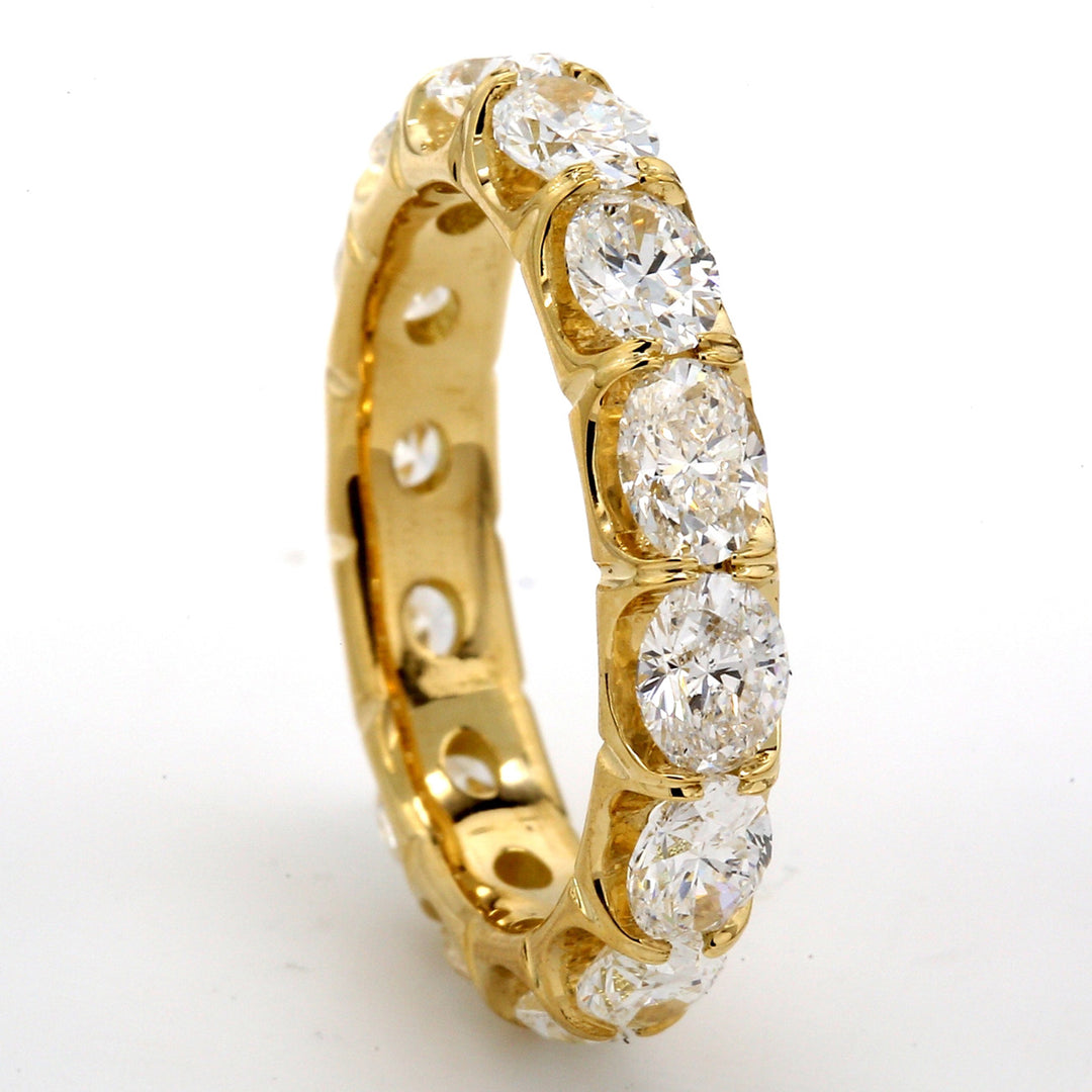 Eternity band east to west style in 18K YG with basket prong set (16) oval cut diamonds.  D2.94ct.t.w.  Size 7.25