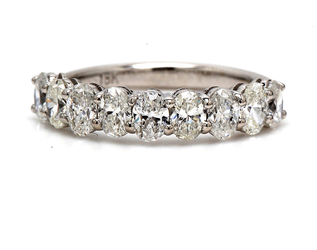 9-stone band in 18K WG with basket prong set oval cut diamonds.  D1.20ct.t.w.  Size 5