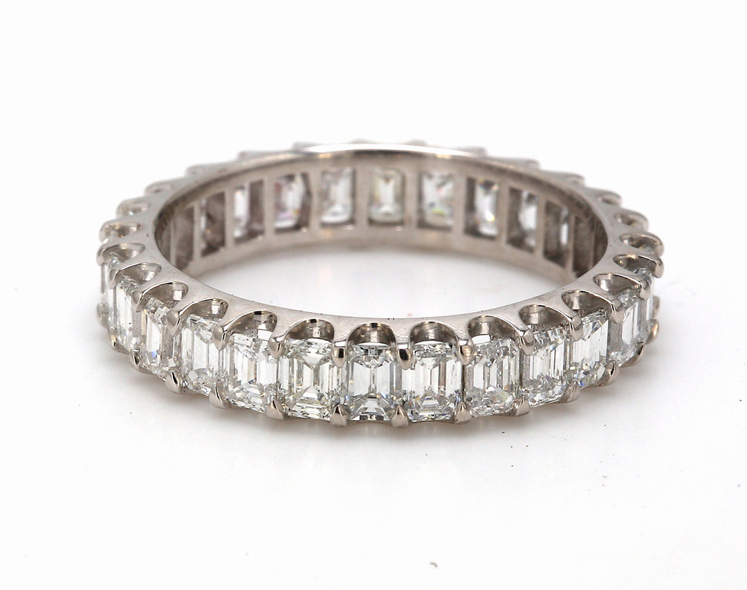 Eternity band in platinum with U-prong set (28) emerald cut diamonds.  D3.14ct.t.w.  Size 7