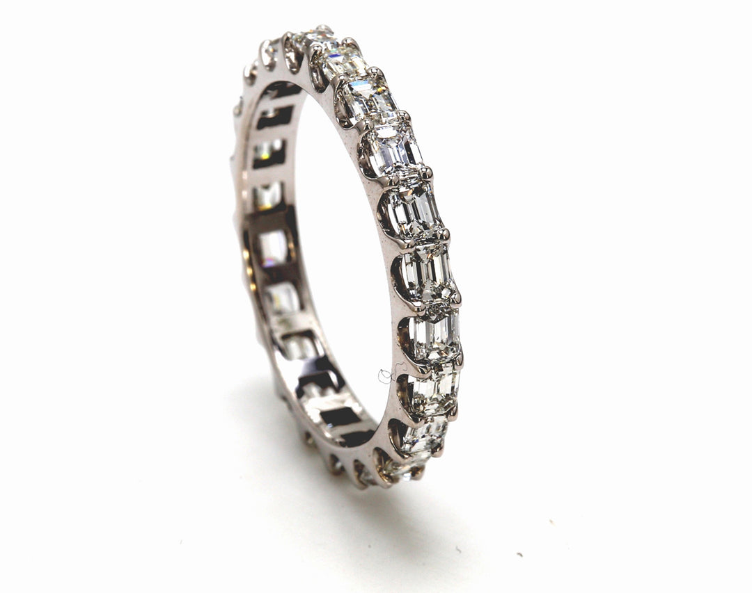 Eternity band east to west style with U-prong set (22) emerald cut diamonds.  D2.10ct.t.w.  Size 7