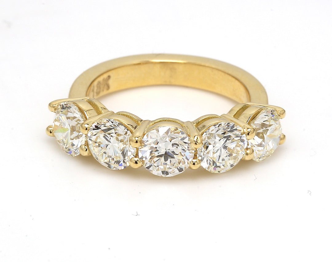 5-stone band in 18K YG with basket prong set round diamonds.  D3.51ct.t.w.  Size 6.25