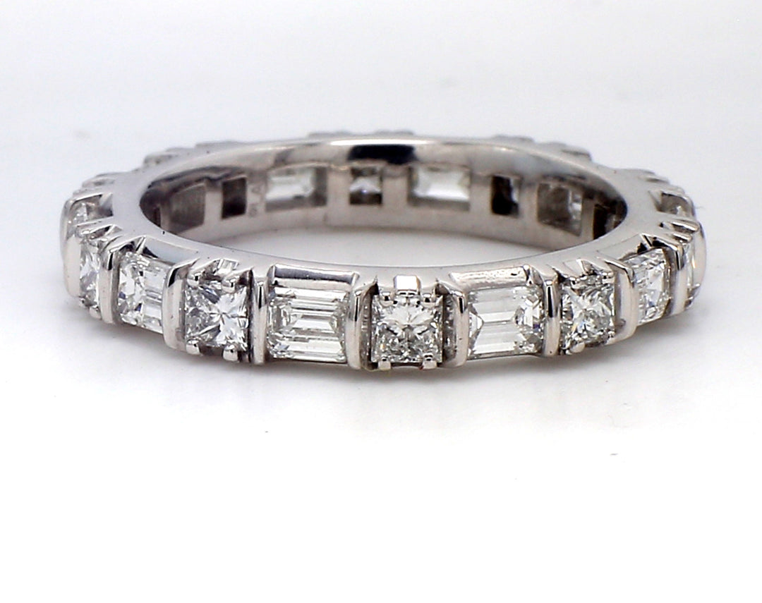 Eternity band bypass style in platinum with prong set (10) emerald cut and (10) princess cut diamonds.  D2.22ct.t.w.  Size 6.25