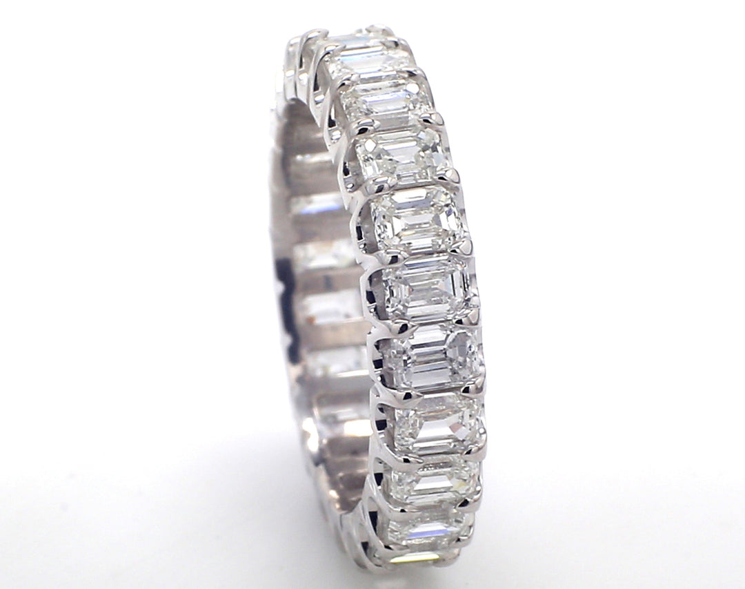 Eternity band in platinum wih U-prong set (24) emerald cut diamonds.  D3.50ct.t.w.  Size 5.75
