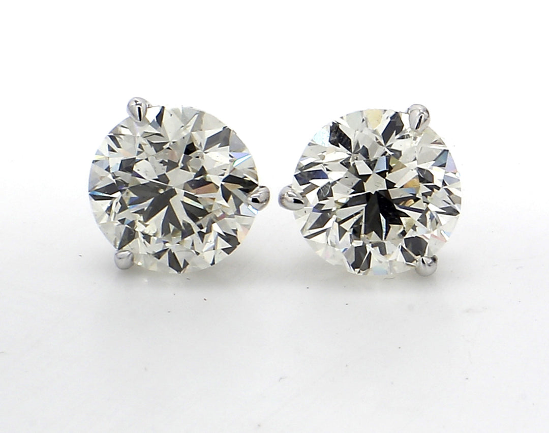 Stud earrings martini style with 3-prong GIA certified M/VS1-SI2 and USA certified K-L/VS2-SI1 round diamonds.  D5.01ct.t.w.
