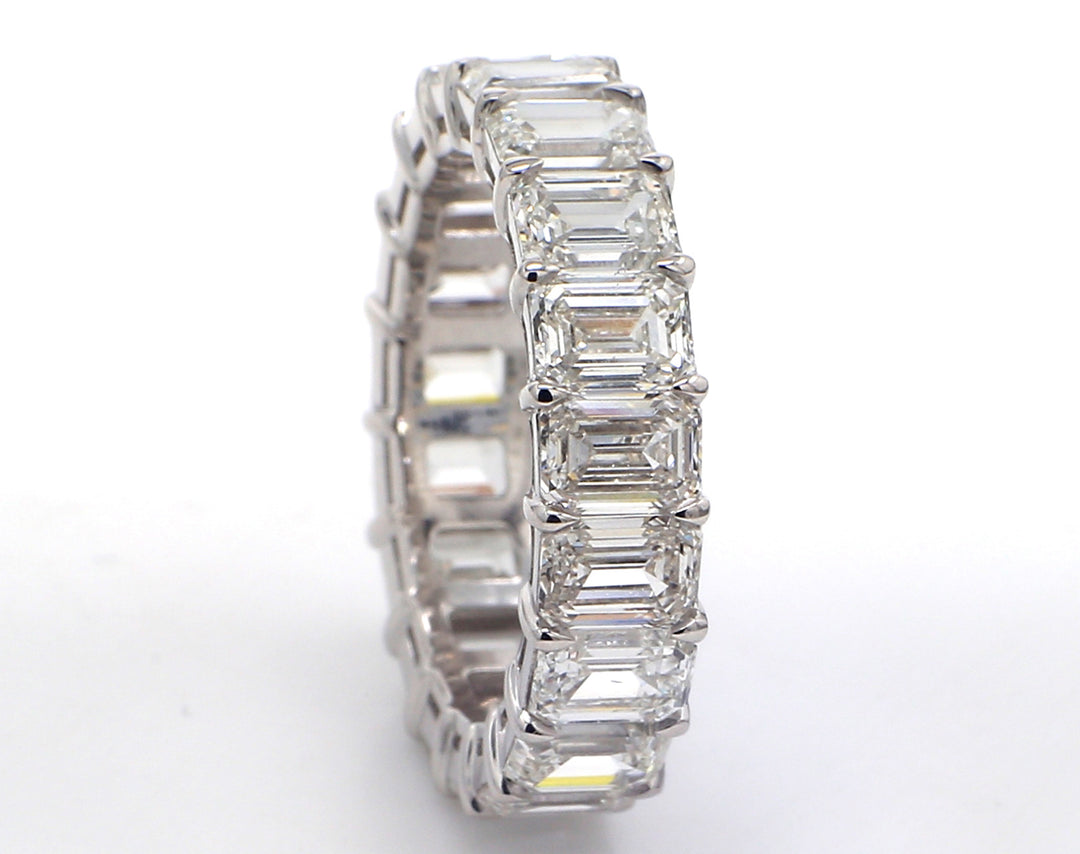 Eternity band in platinum with basket claw set GIA certified G-I/VVS1-VS2 (19) emerald cut diamonds.  D7.77ct.t.w.  Size 7