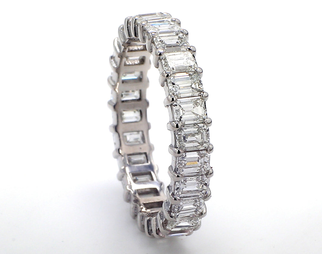 Eternity band in platinum with prong set (26) emerald cut diamonds.  D3.52ct.t.w.  Size 7.25