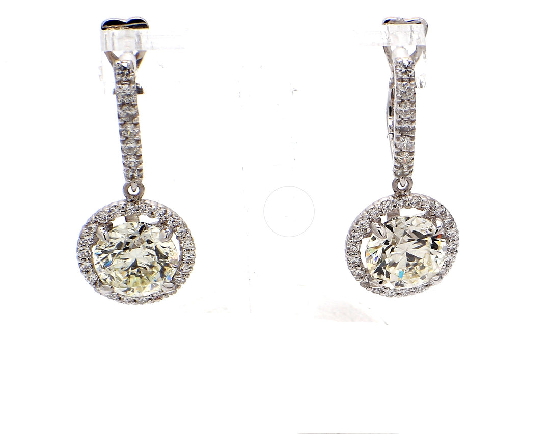 Halo dangling earrings with prong set round diamonds.  D4.84ct.t.w.  (Centers 4.00ct.t.w.)