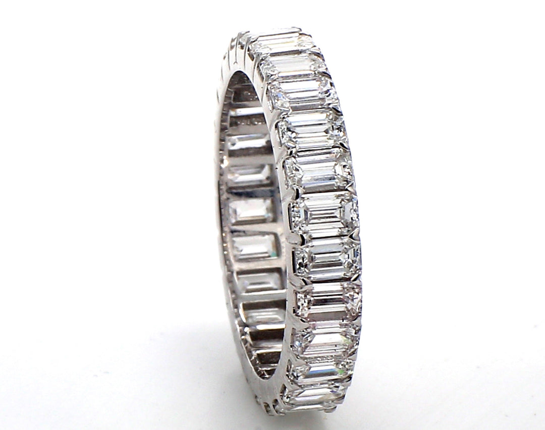 Eternity band with prong set (27) emerald cut diamonds.  D2.45ct.t.w.  Size 4.75