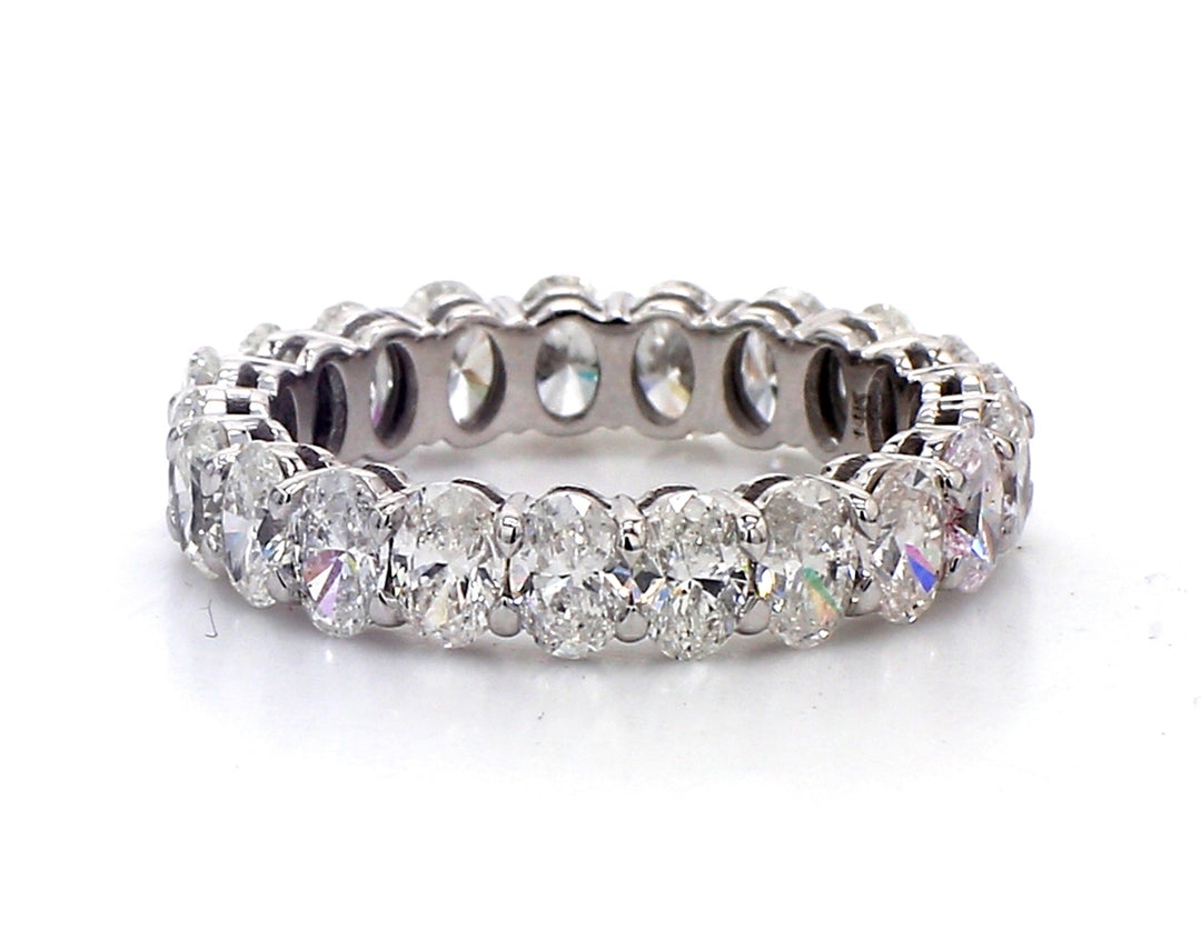 Eternity band in white gold with basket prong set (21) oval cut diamonds.  D2.89ct.t.w.  Size 4.75