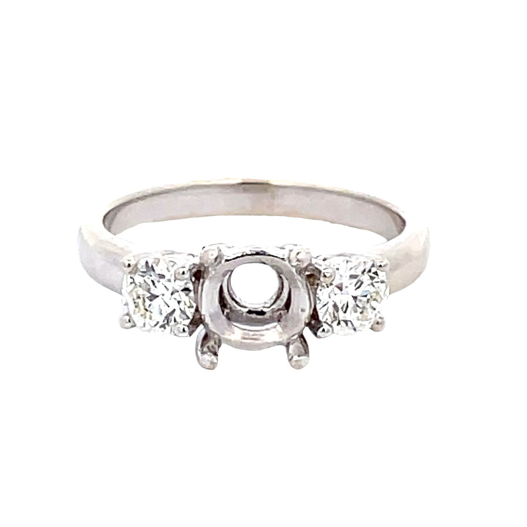 3-stone semi-mount with 4-prong set round diamonds.  D0.60ct.t.w.