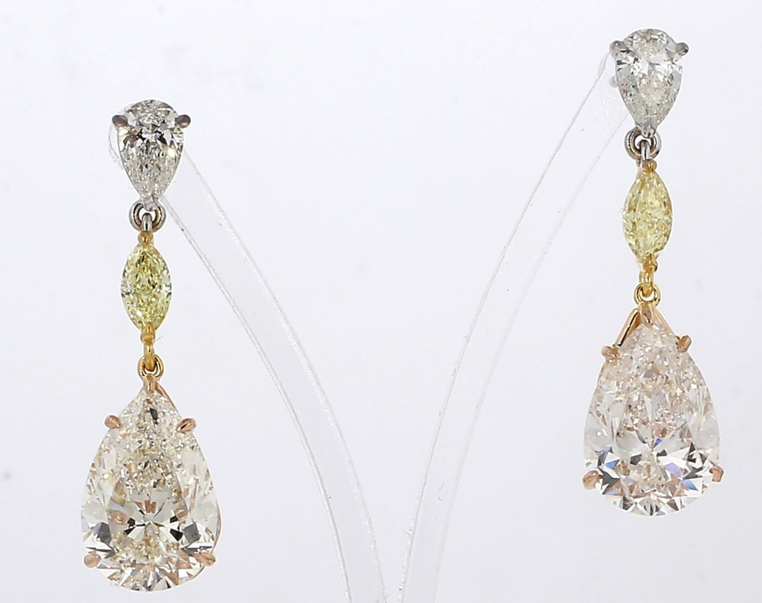 Dangling earrings in 18K YG and RG with prong set GIA certified J-K/SI1-2 pear shape centers, H/SI2 pear shapes, and FY marquise diamonds.  D11.79ct.t.w.