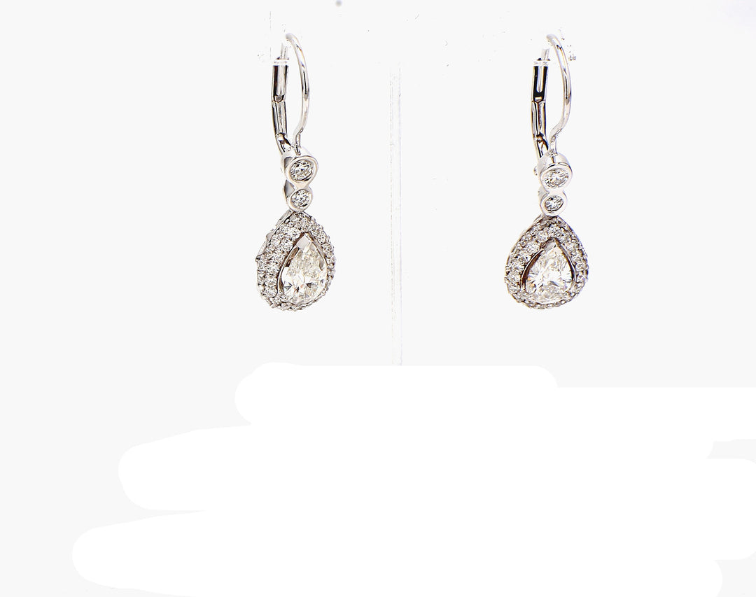 Halo dangling earrings with GIa certified E/SI2 pear shape centers and prong set round diamonds.  D2.40ct.t.w.