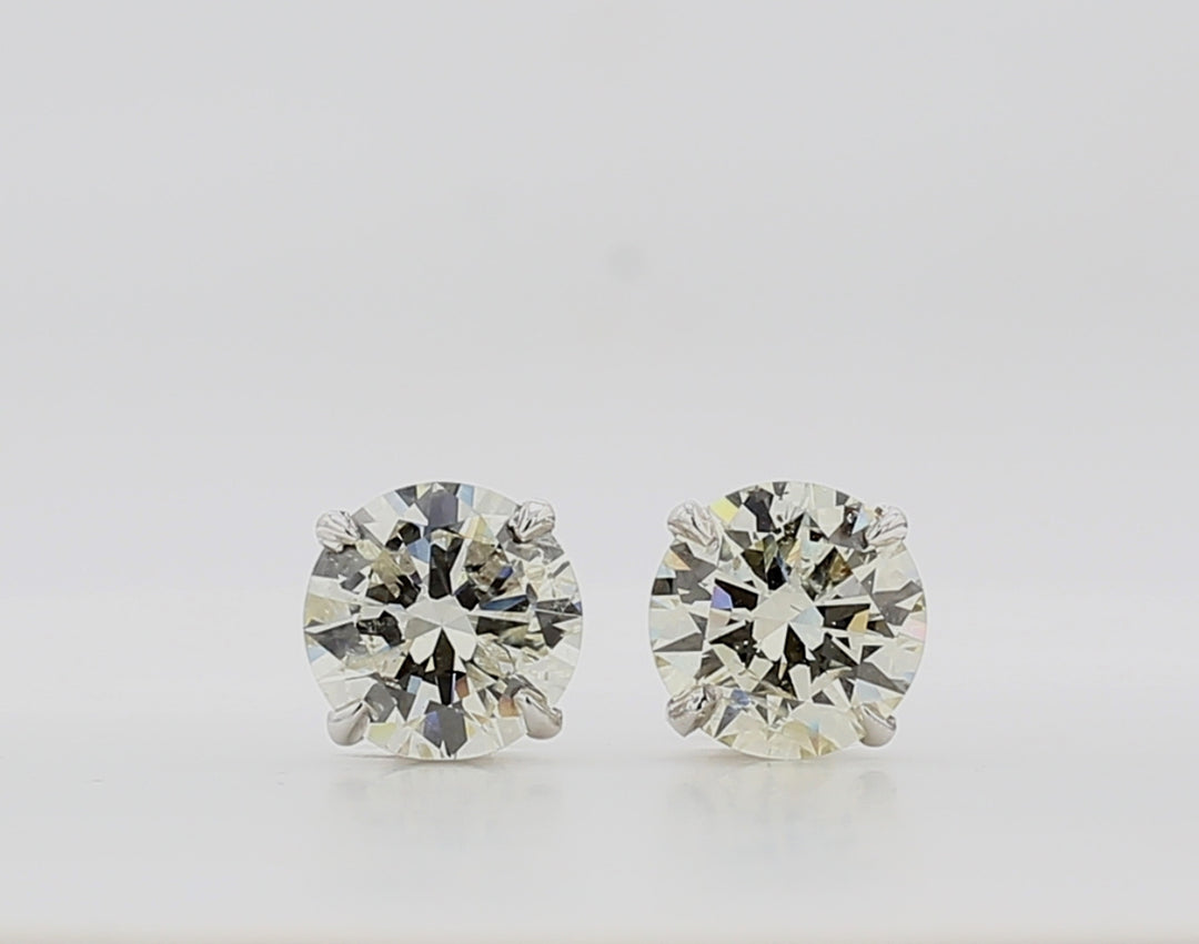 Screw back stud earrings with 4-prong set round diamonds.  D6.01ct.t.w.