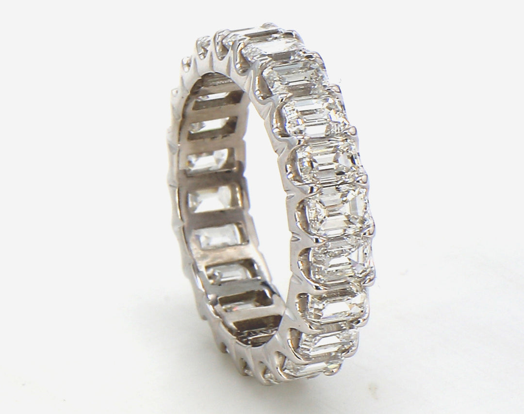 Eternity band in platinum with U-prong set (22) emerald cut diamonds.  D4.21ct.t.w.  Size 5