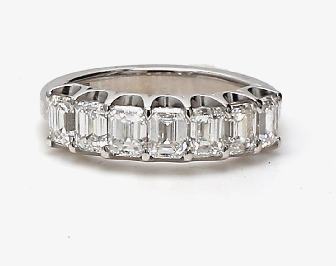 7-stone band in platinum with U-prong set emerald cut diamonds.  D1.69ct.t.w.  Size 4.75