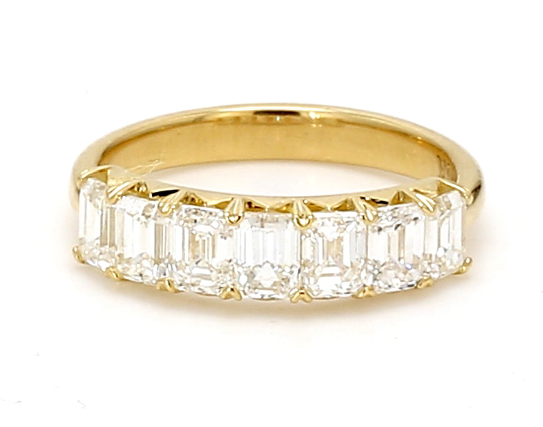 7-stone band in 18K YG with prong set emerald cut diamonds.  D1.66ct.t.w.  Size 5