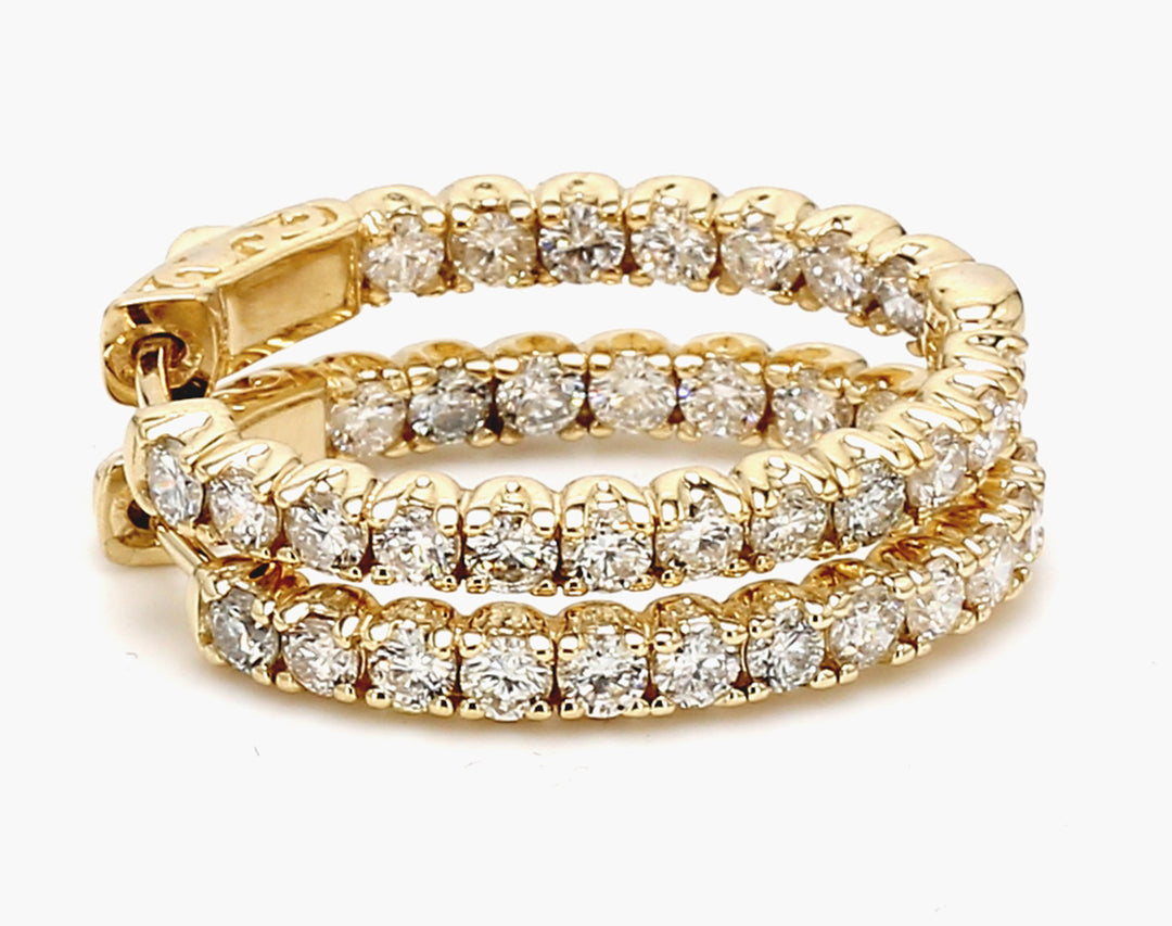1"" Oval shaped inside out hoop earrings in 14K YG with prong set round diamonds.  D2.66ct.t.w.