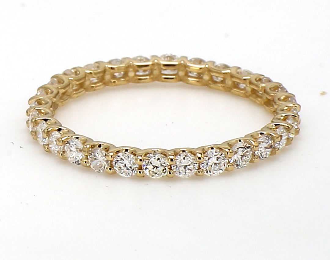 Eternity band in yellow gold with U-prong set (28) round diamonds.  D0.54ct.t.w.  Size 3.5