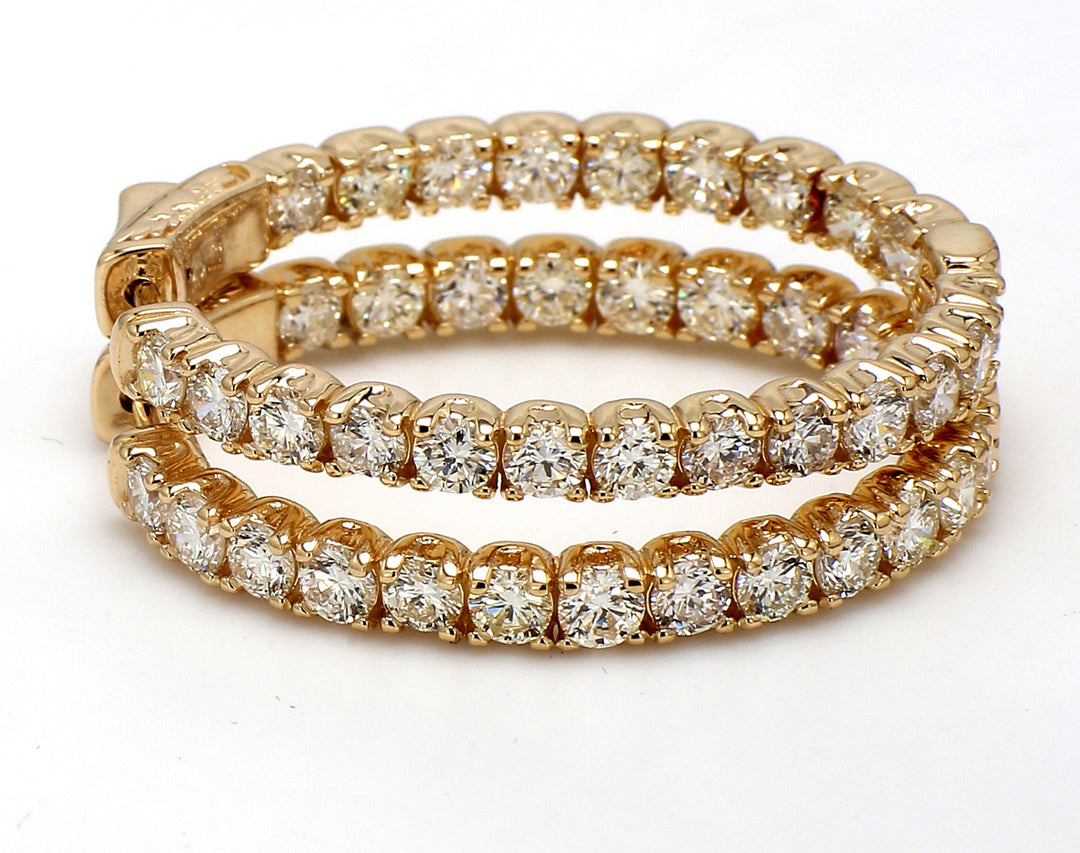 1.25"" Oval shape inside out hoop earrings in yellow gold with prong set (44) round diamonds.  D4.75ct.t.w.