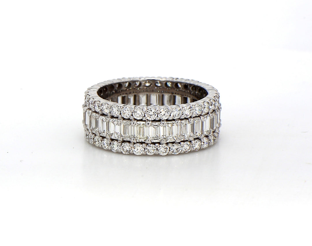 Eternity band in 18K WG with prong set emerald cuts on the center and round diamonds on each side.  D4.89ct.t.w.  Size 7