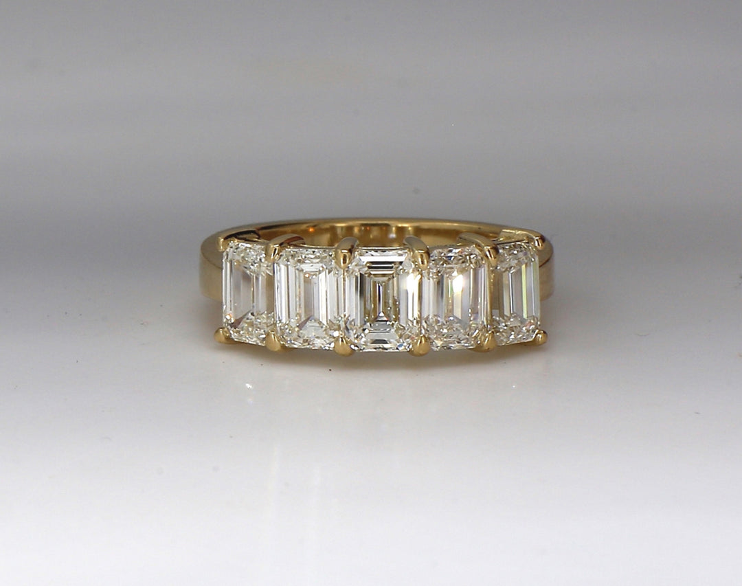 5-stone band in 18K YG with shared prong set GIA certified I/VVS1-VS2 emerald cut diamonds.  D2.58ct.t.w.  Size 6