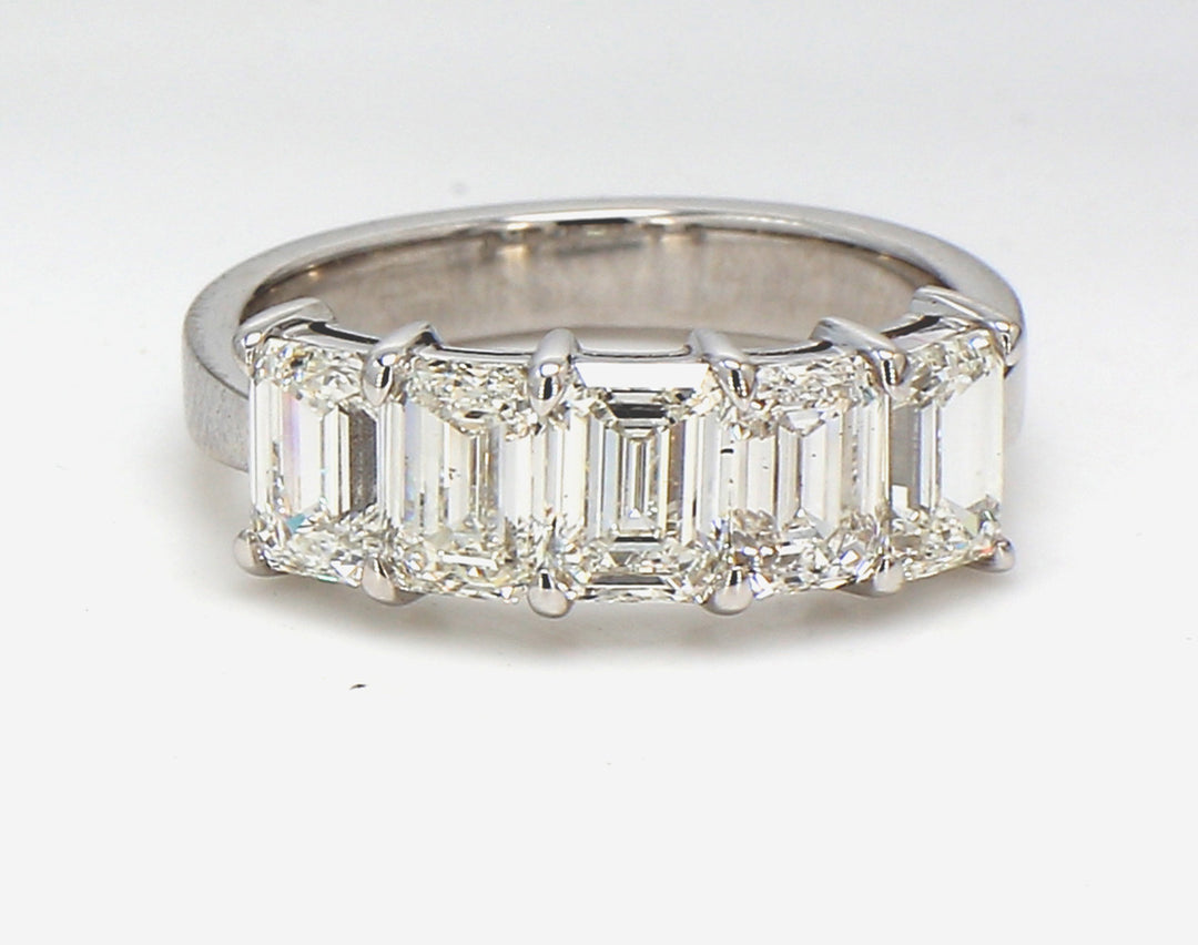 5-stone band in 18K WG with shared prong set GIA certified I/VVS1-VS2 emerald cut diamonds.  D2.59ct.t.w.  Size 5.75