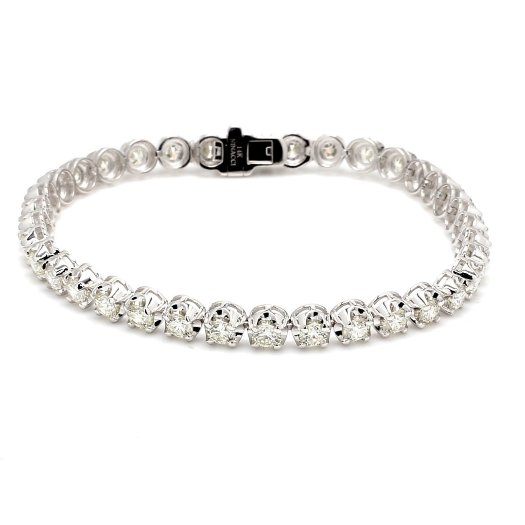 7"" Tennis bracelet in 18K WG with crown head set G-H/VS2-SI1 (27) round diamonds.  D9.51ct.t.w.