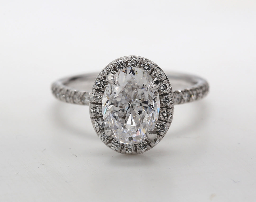 Halo ring in platinum with pre-set rounds around GIA certified D/VS2 oval diamond center.  D2.92ct.t.w.  (Center - 2.50ct.)