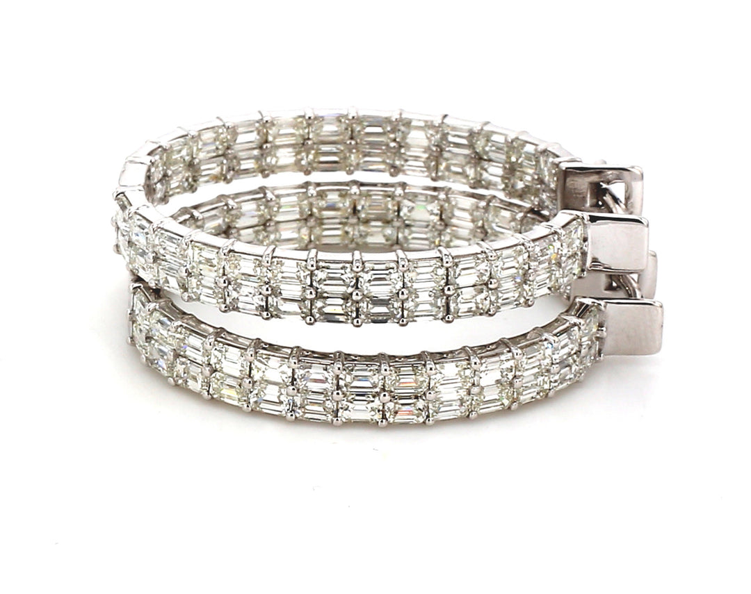 1.25"" Oval shaped inside out hoop earrings with double row prong set emerald cut diamonds.  D8.47ct.t.w.