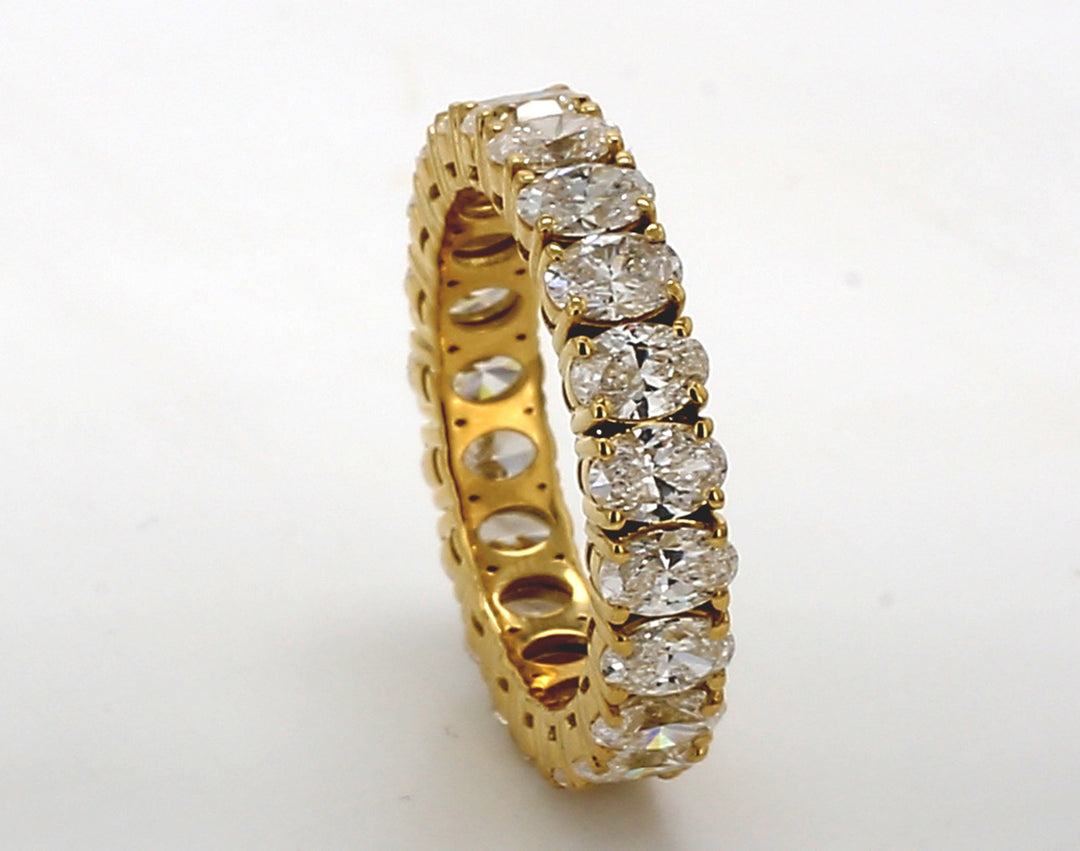 Eternity band in 18K YG with basket prong set (21) oval cut diamonds.  D3.92ct.t.w.  Size 7