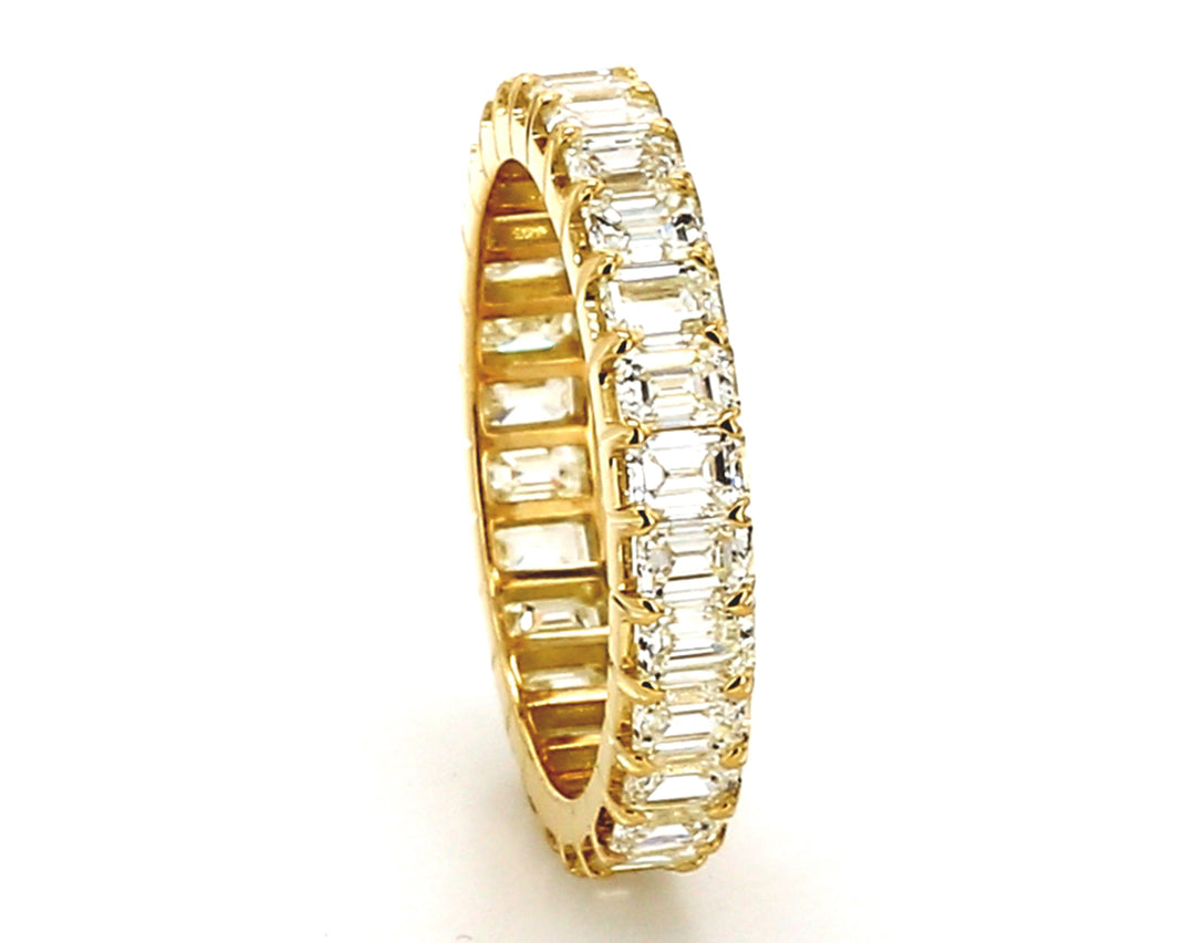 Eternity band in 18K YG with prong set (28) emerald cut diamonds.  D2.71ct.t.w.  Size  6